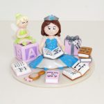 figurine anniversaire petite fille 4 ans assise, en robe de princesse, en train de lire, avec fée clochette