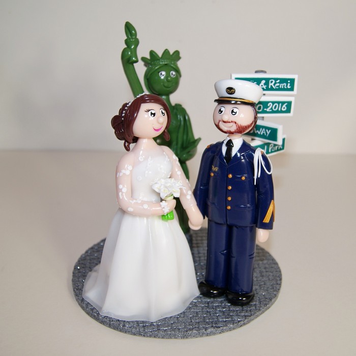 Figurines de mariage avec mariée en robe de mariage, marié en uniforme de l'armée, devant la Statue de la Liberté, New York