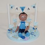 figurine enfant en tenue de baptême, thème gourmandise et moulin à vent, camaieu de bleu